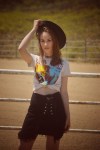 Girl with a cowboy hat and a guns and roses t-shirt