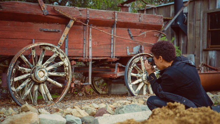 A photographers taking pictures of a wagon wheel at stagecoach inn in Newbury Park ca