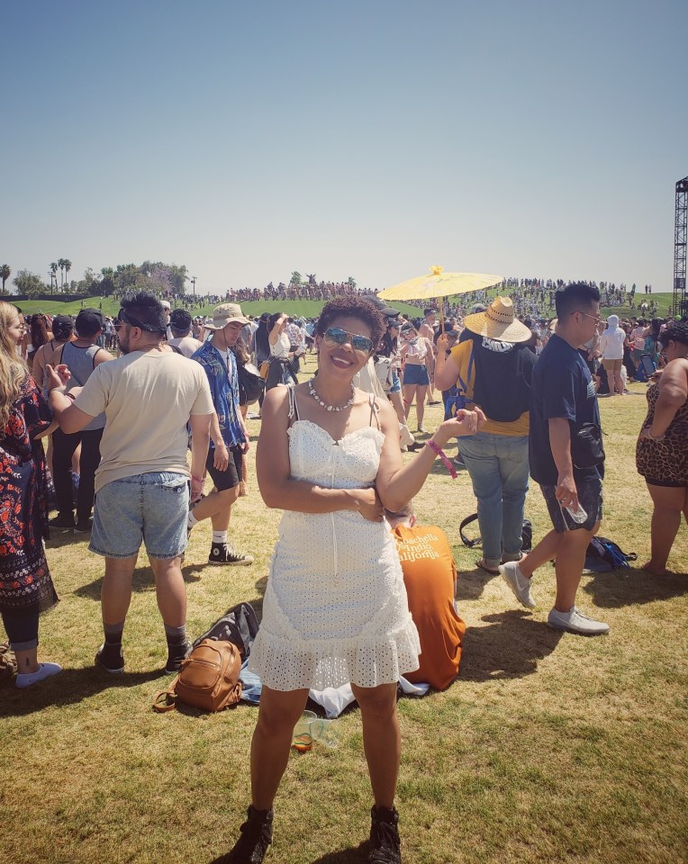 Girl in a white dress standing in front of a crowd