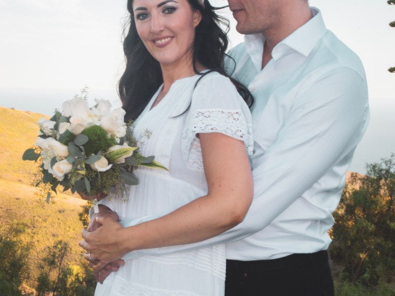Elopement couple with white rose bouquet