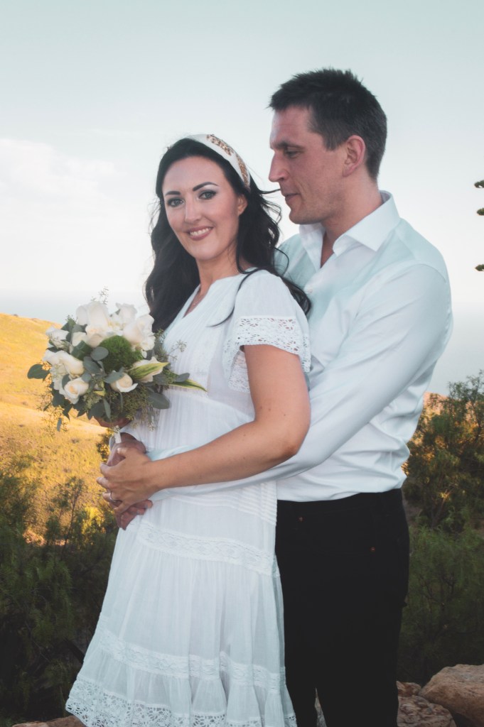 Elopement couple with white rose bouquet