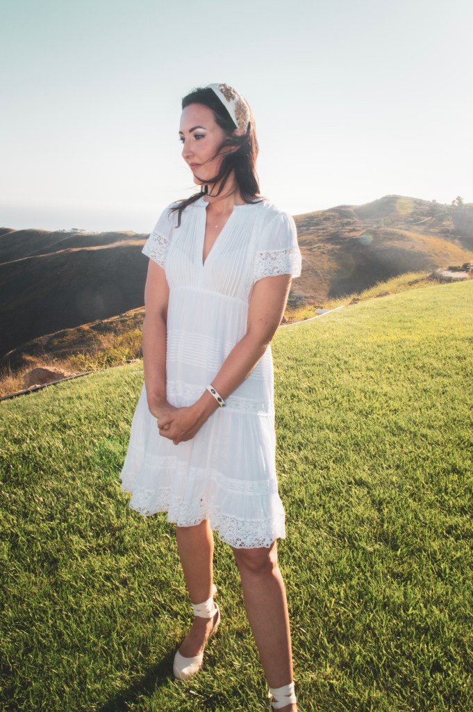 Bride on a mountainside overlooking the ocean