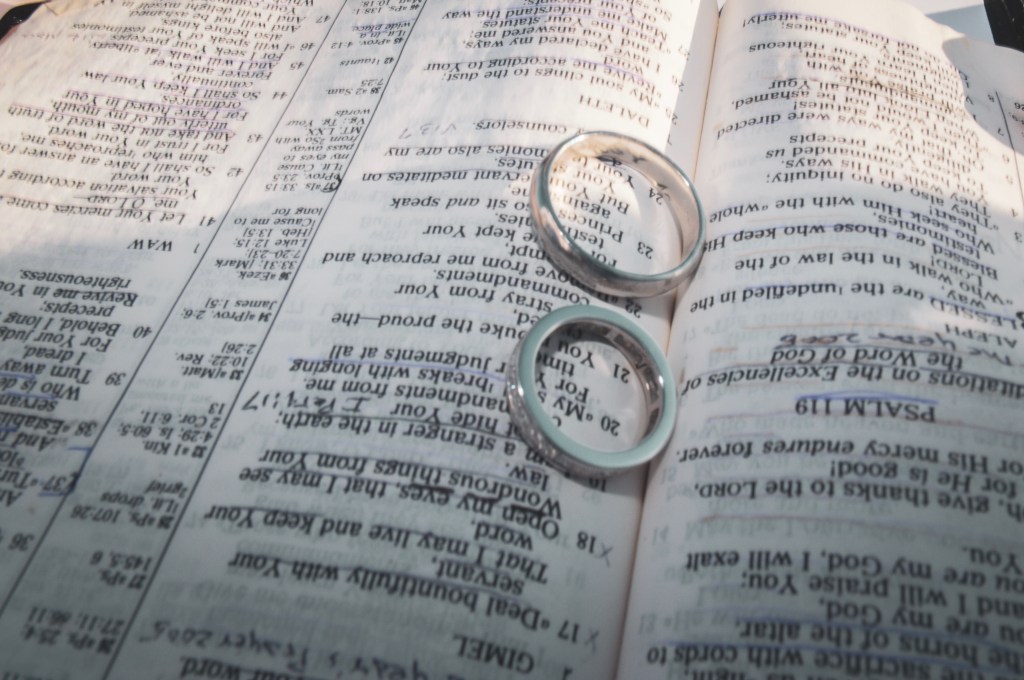 Wedding bands on a bible opened to psalm 119