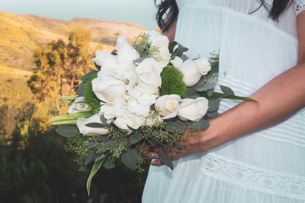 Bride holding white flower bouquet