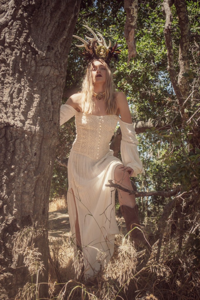 Woman standing by an oak tree