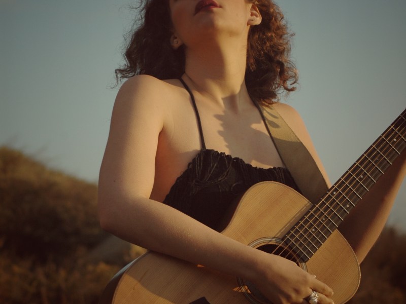 a woman with a guitar